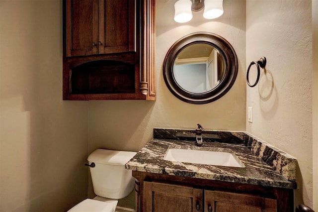 bathroom featuring toilet and vanity