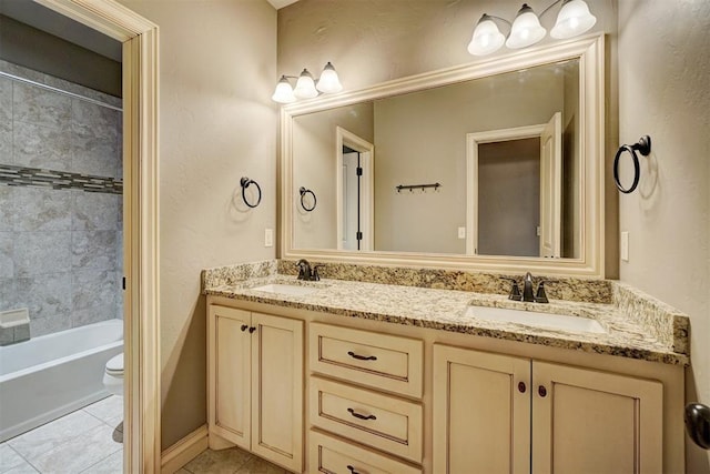 full bathroom with toilet, vanity, tile patterned flooring, and tiled shower / bath combo