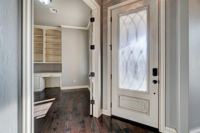 entrance foyer featuring dark wood-type flooring and ornamental molding