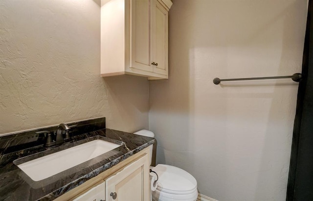 bathroom with toilet and vanity