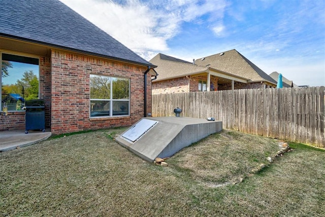 entry to storm shelter featuring a yard