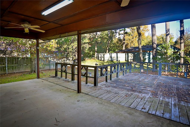 wooden terrace featuring a shed and ceiling fan