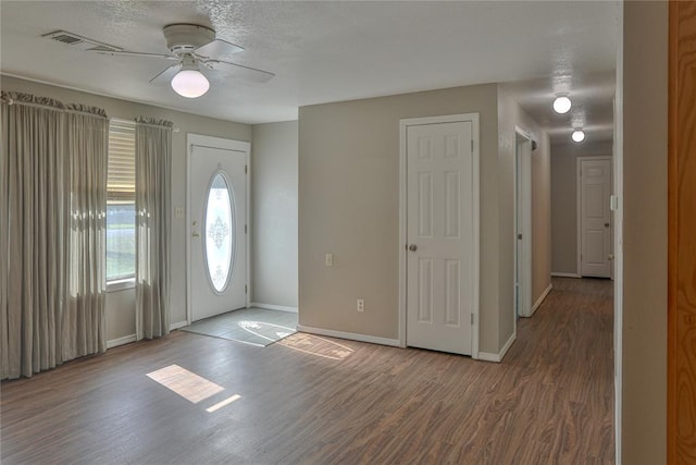 foyer with ceiling fan, wood-type flooring, and a textured ceiling