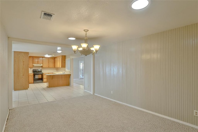 kitchen featuring black electric range, light colored carpet, an inviting chandelier, and hanging light fixtures