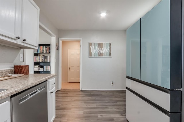 kitchen featuring dishwasher, light hardwood / wood-style floors, and white cabinetry