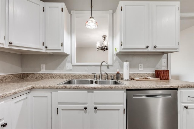 kitchen featuring hanging light fixtures, sink, white cabinets, and stainless steel dishwasher