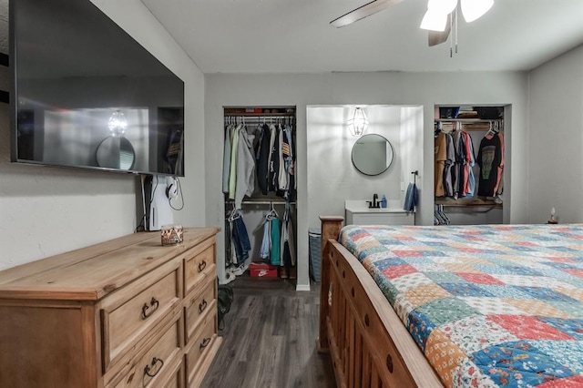 bedroom with multiple closets, ceiling fan, and dark hardwood / wood-style flooring