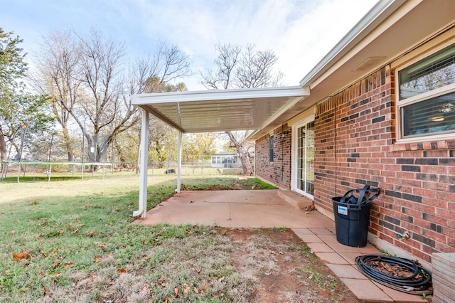 view of yard with a patio and a trampoline