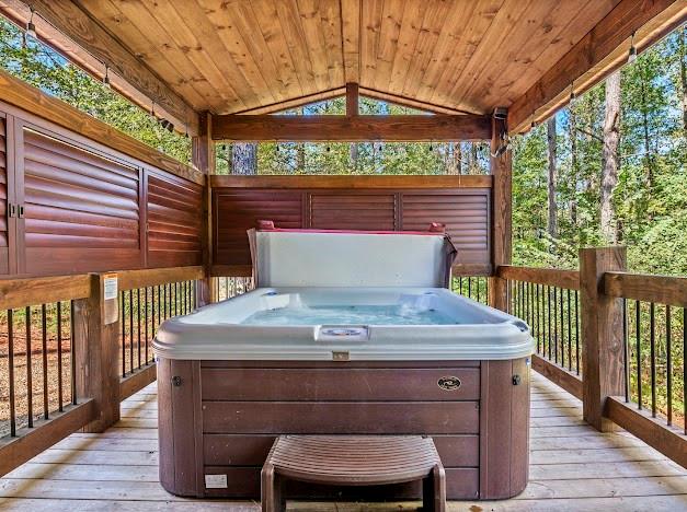 wooden deck featuring a hot tub