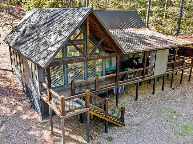 rear view of property featuring a wooden deck