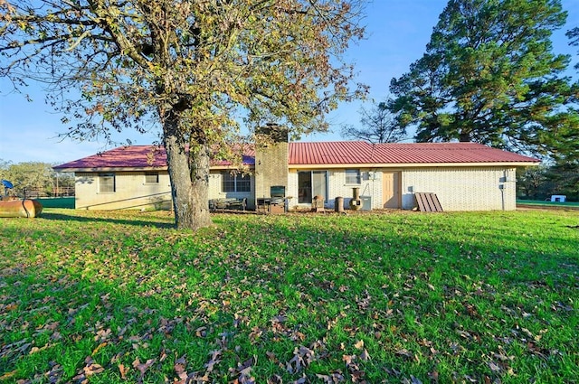 rear view of house with a yard