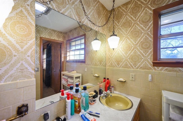 bathroom with vanity and tile walls