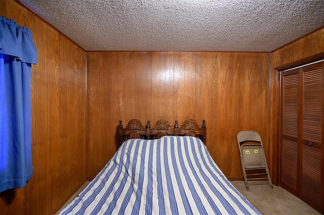 unfurnished bedroom featuring carpet floors, a closet, and wooden walls