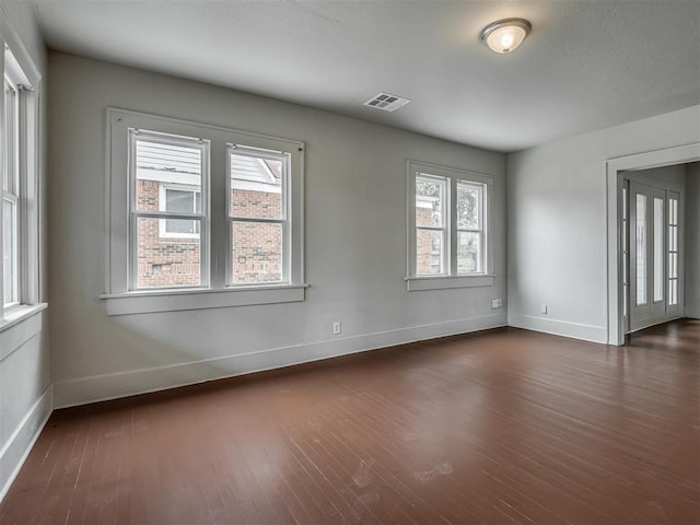 unfurnished room featuring dark wood-type flooring