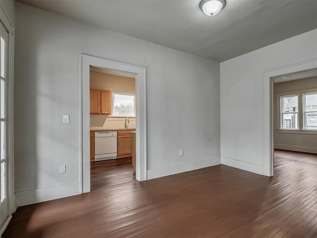 empty room with sink and dark wood-type flooring