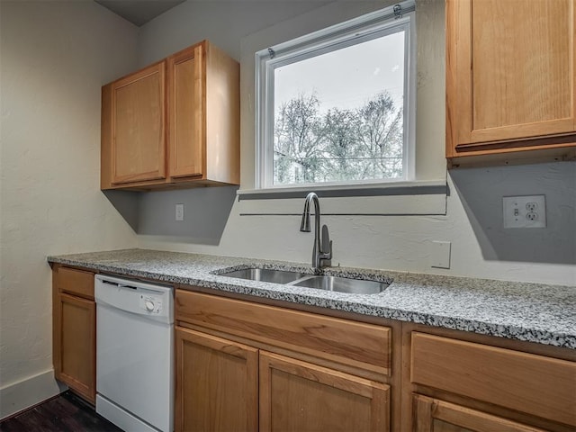 kitchen with white dishwasher, light stone counters, dark hardwood / wood-style flooring, and sink