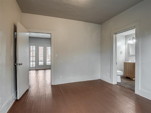 spare room with dark hardwood / wood-style floors and sink