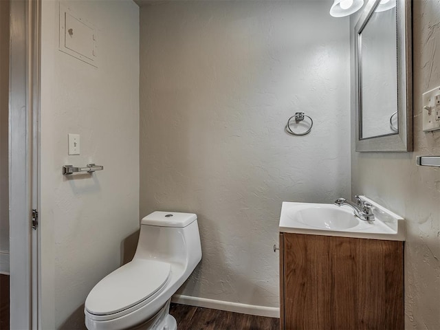 bathroom featuring hardwood / wood-style flooring, vanity, and toilet