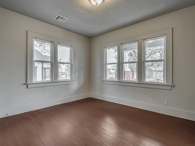 spare room with wood-type flooring