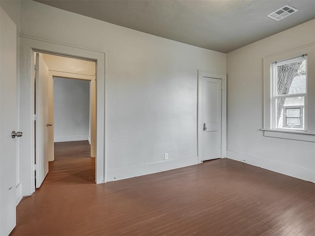 spare room featuring dark hardwood / wood-style flooring