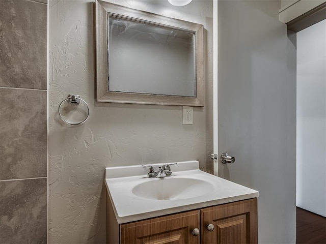 bathroom with hardwood / wood-style floors and vanity