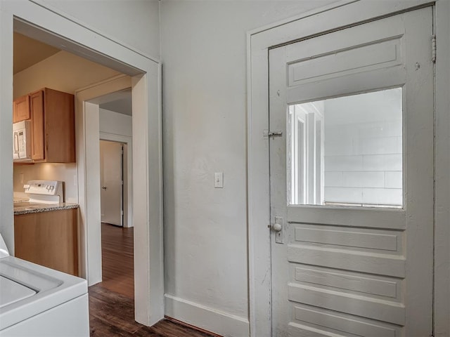 doorway to outside with washer / clothes dryer and dark hardwood / wood-style flooring