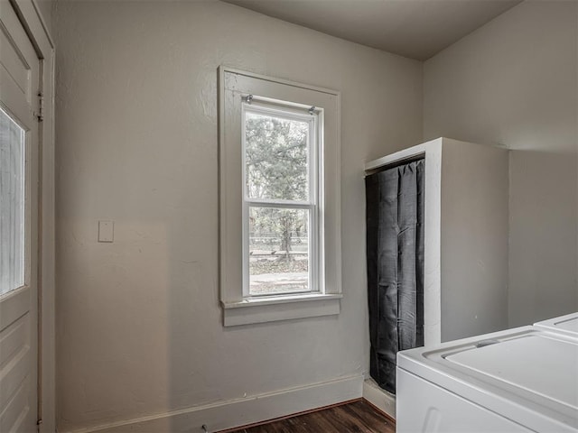 laundry room featuring dark hardwood / wood-style floors and a healthy amount of sunlight