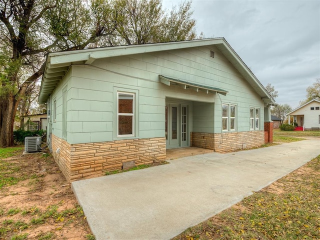 view of front of house featuring a patio area and central air condition unit