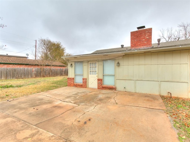 rear view of property with a patio and a lawn