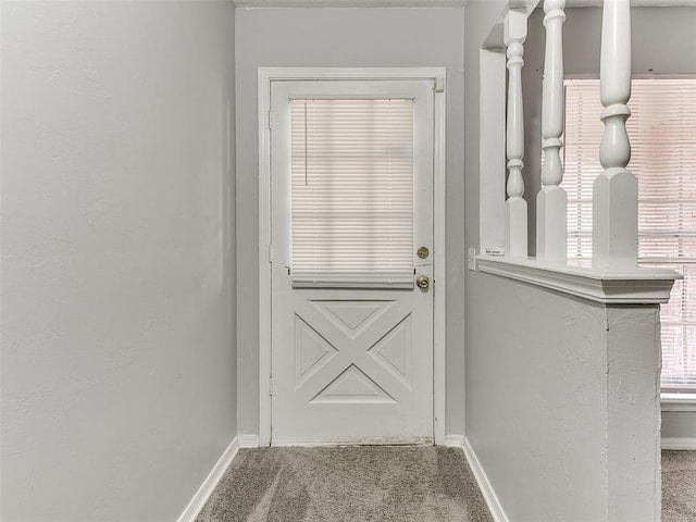 doorway to outside featuring carpet floors