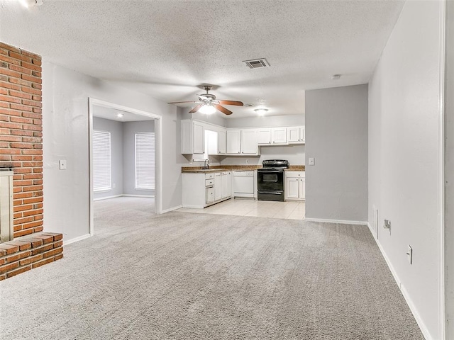 kitchen featuring light carpet, white cabinets, white dishwasher, a textured ceiling, and black range with electric cooktop