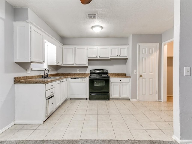 kitchen with white dishwasher, white cabinets, and electric range