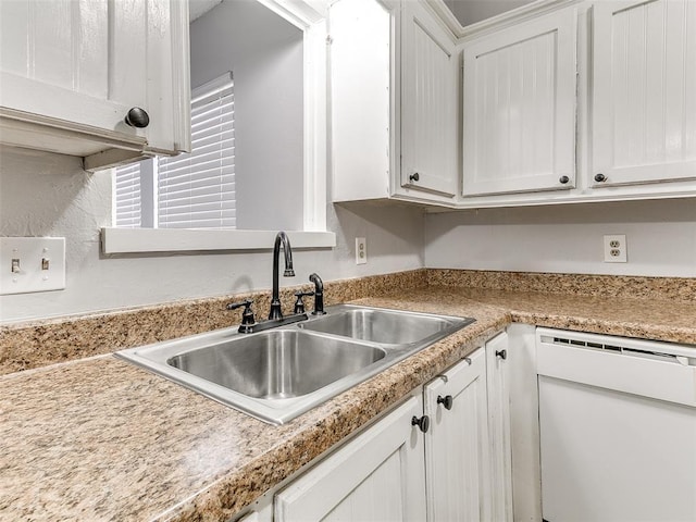 kitchen featuring white cabinetry, dishwasher, and sink