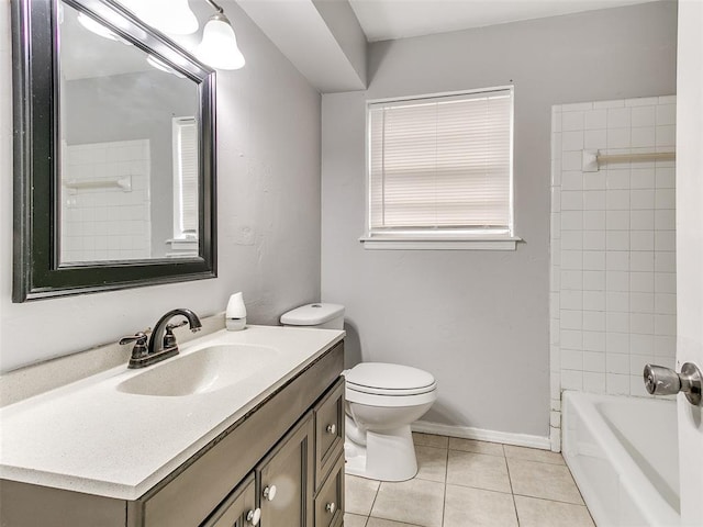 full bathroom featuring tile patterned floors, tiled shower / bath, vanity, and toilet