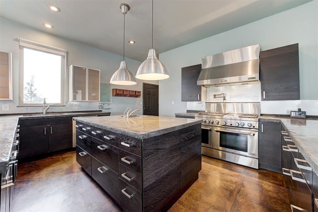 kitchen with a center island with sink, range with two ovens, decorative light fixtures, light stone counters, and extractor fan