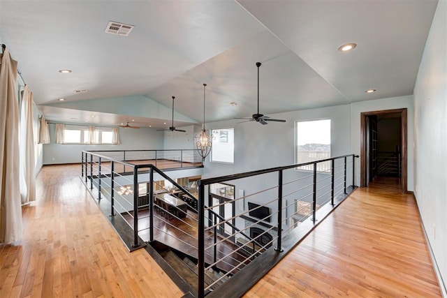 hall with light hardwood / wood-style floors and lofted ceiling