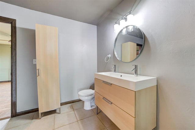 bathroom featuring tile patterned floors, vanity, and toilet