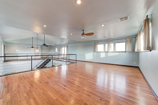 unfurnished room with light hardwood / wood-style floors, ceiling fan, and lofted ceiling