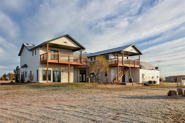 back of property with a deck and cooling unit