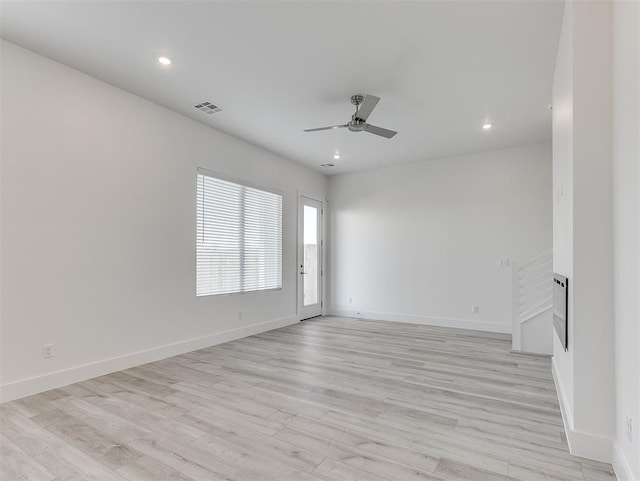 spare room featuring light wood-type flooring and ceiling fan