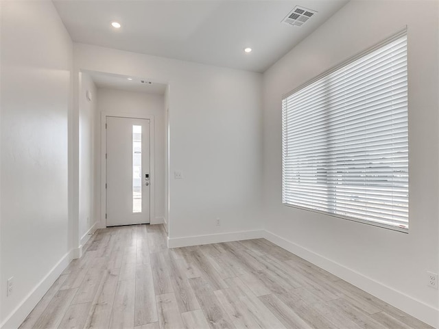 foyer featuring a wealth of natural light and light hardwood / wood-style flooring