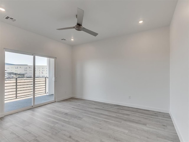 spare room featuring light wood-type flooring and ceiling fan