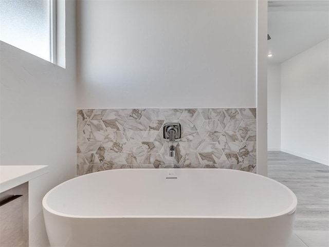 bathroom featuring vanity and a tub to relax in