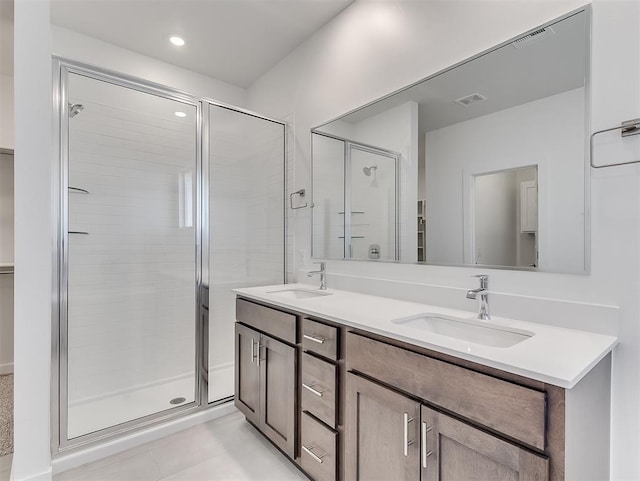 bathroom with vanity, an enclosed shower, and tile patterned flooring