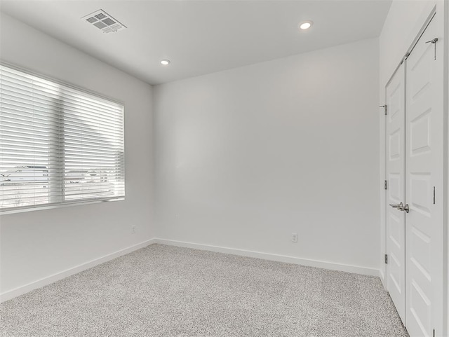 unfurnished room featuring light colored carpet