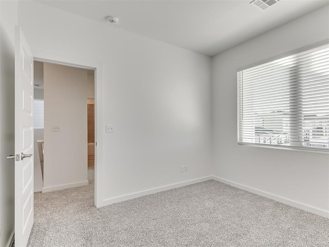 spare room with light colored carpet