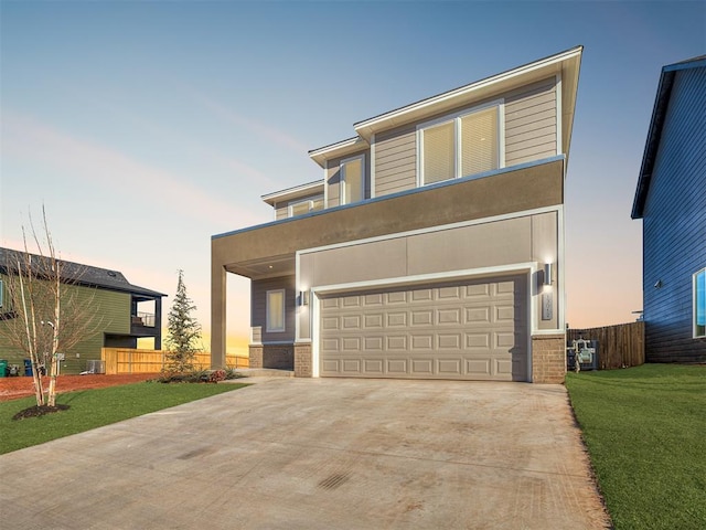 view of front of property with a yard and a garage