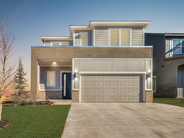 view of front of house with a garage and a yard