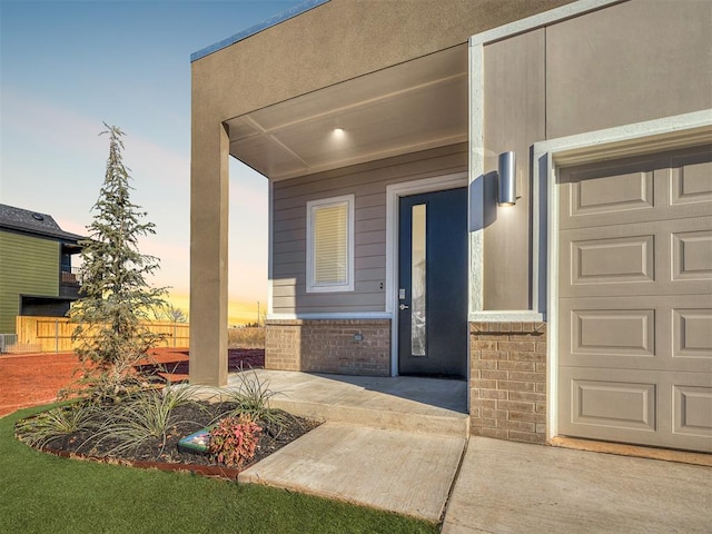 exterior entry at dusk with a garage