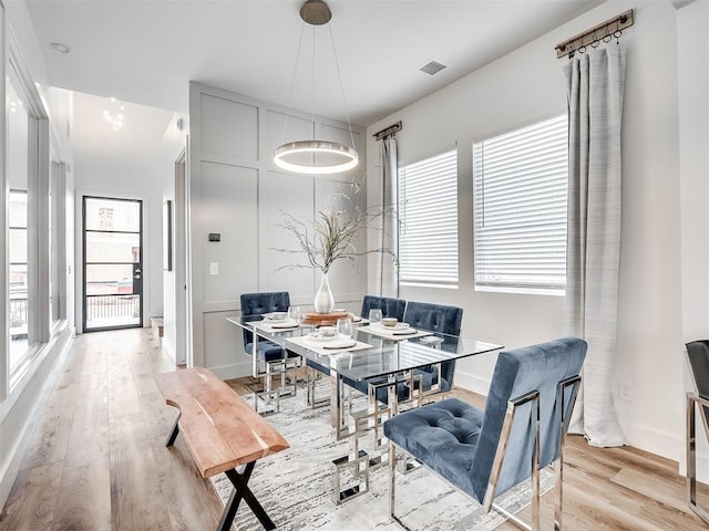 dining room with breakfast area and light hardwood / wood-style floors